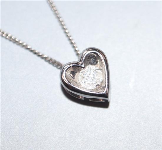 A modern 9ct white gold and diamond set heart shaped pendant necklace, pendant 6mm.